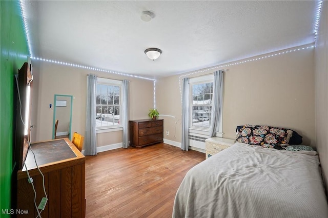 bedroom featuring hardwood / wood-style flooring and multiple windows