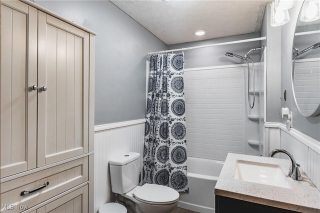 full bathroom featuring shower / bath combo, vanity, and toilet