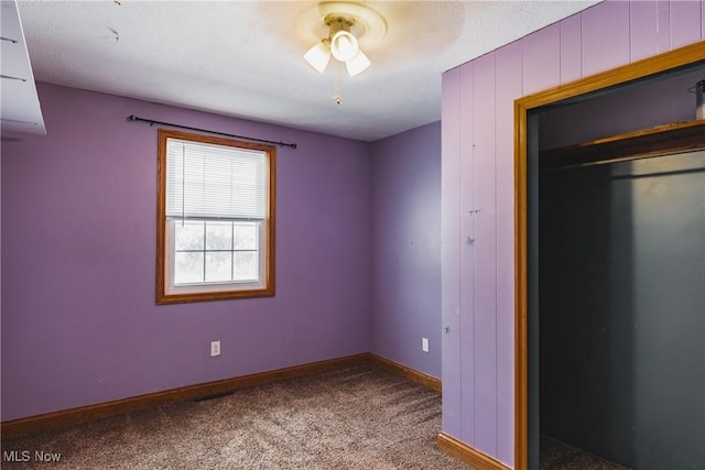 unfurnished bedroom featuring carpet floors and a closet