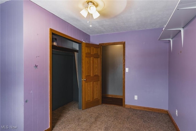 unfurnished bedroom featuring a closet, ceiling fan, and carpet