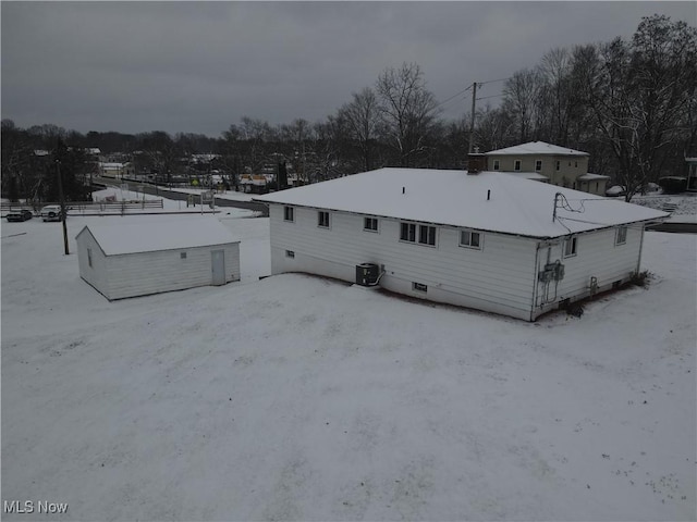 snow covered property featuring cooling unit