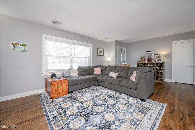 living room with dark hardwood / wood-style flooring