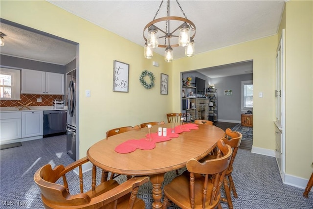 dining area featuring plenty of natural light and a notable chandelier