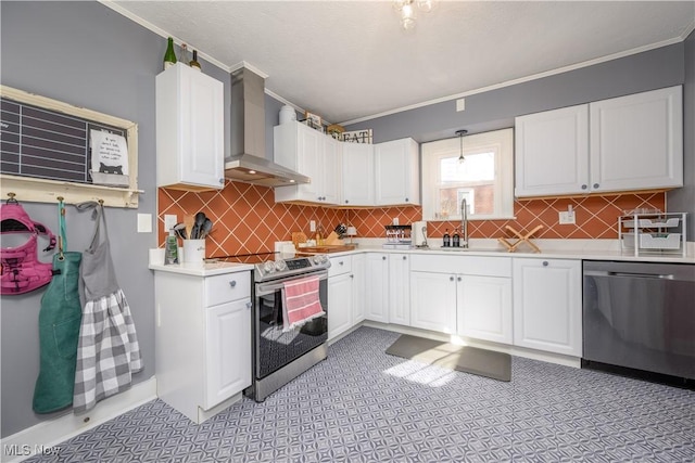 kitchen with white cabinetry, stainless steel appliances, wall chimney range hood, pendant lighting, and sink