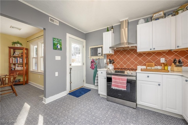 kitchen with white cabinetry, tasteful backsplash, electric stove, ornamental molding, and wall chimney exhaust hood