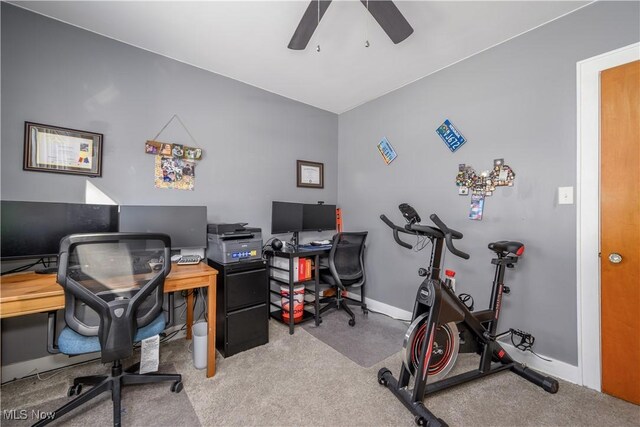 carpeted home office with ceiling fan