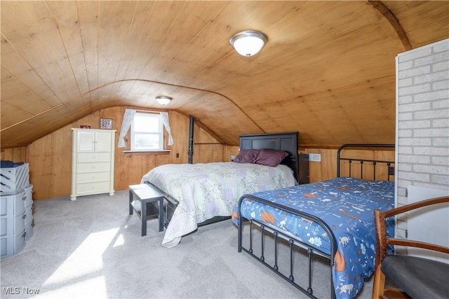 bedroom featuring vaulted ceiling, wood ceiling, carpet floors, and wooden walls