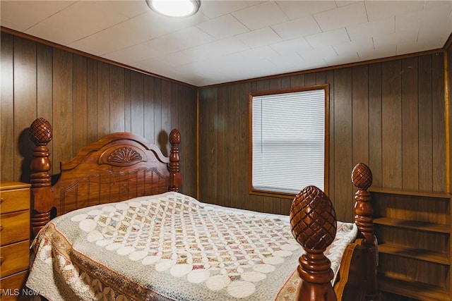 bedroom featuring wood walls