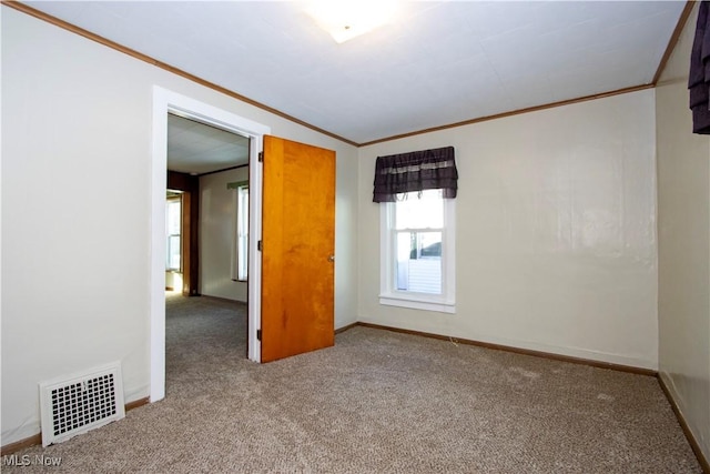 unfurnished room with light carpet and crown molding