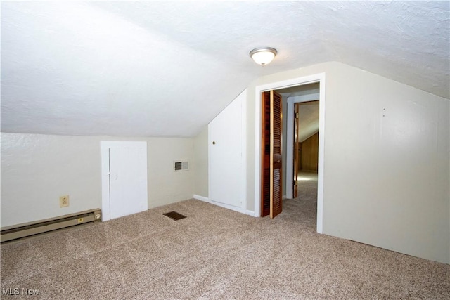 bonus room featuring baseboard heating, a textured ceiling, carpet flooring, and vaulted ceiling