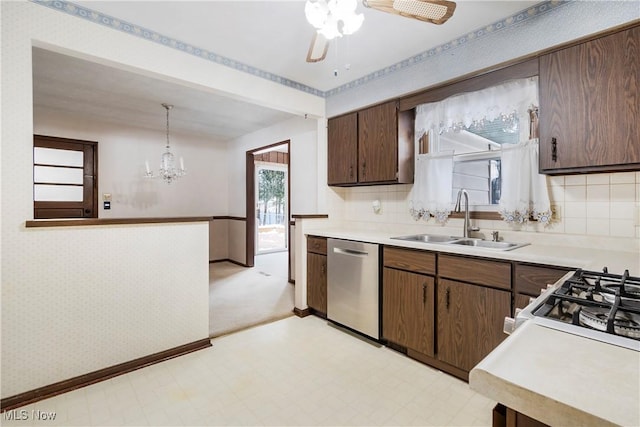 kitchen featuring ceiling fan with notable chandelier, dishwasher, tasteful backsplash, sink, and hanging light fixtures