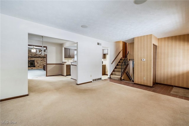 carpeted empty room featuring a textured ceiling