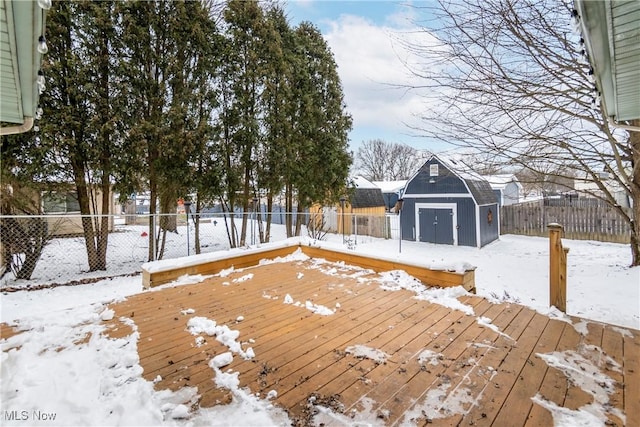 snow covered deck with a storage unit