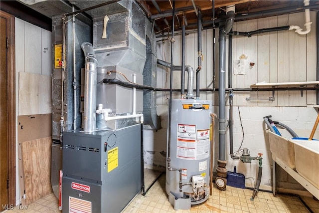 utility room with heating unit and gas water heater