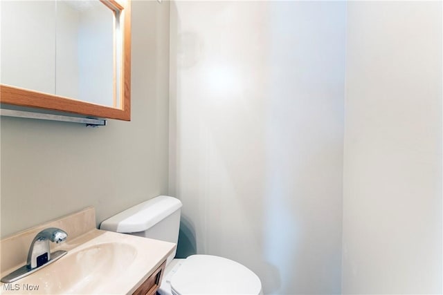 bathroom featuring toilet and vanity