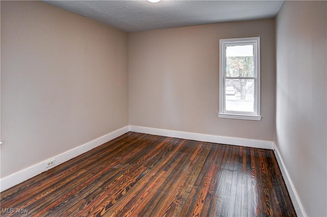 empty room featuring dark hardwood / wood-style floors