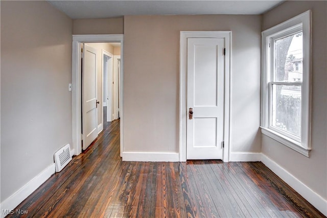 unfurnished bedroom featuring dark hardwood / wood-style floors