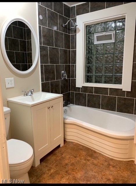 full bathroom featuring shower / bathing tub combination, vanity, tile patterned floors, and toilet