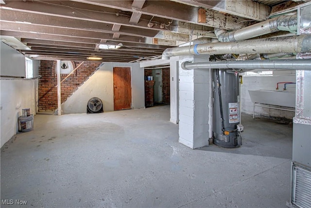 basement featuring sink and gas water heater