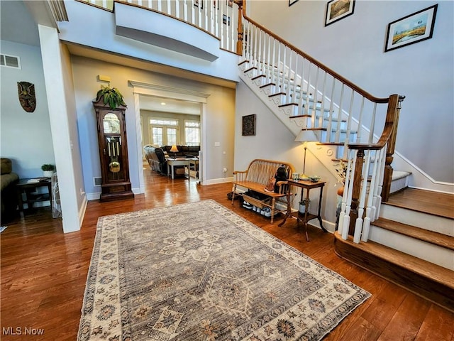 entrance foyer with wood-type flooring and a high ceiling