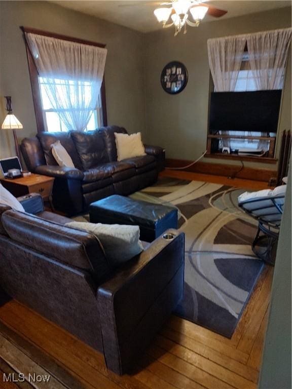 living room featuring wood-type flooring and ceiling fan