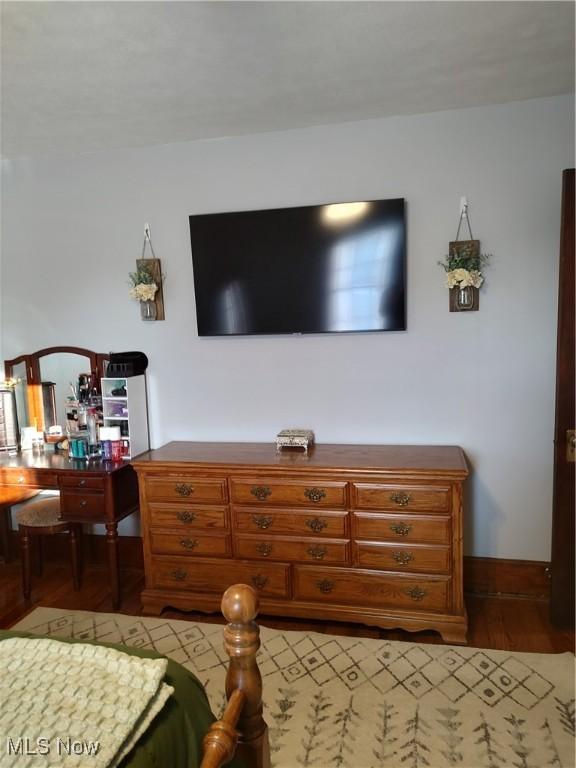 bedroom with hardwood / wood-style flooring