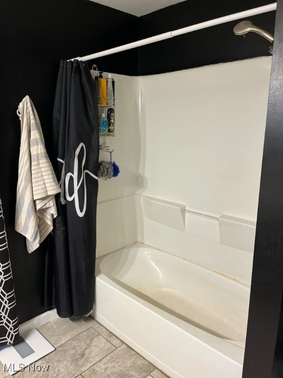 bathroom featuring tile patterned floors and shower / tub combo with curtain