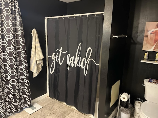 bathroom with toilet, a shower with curtain, and tile patterned flooring