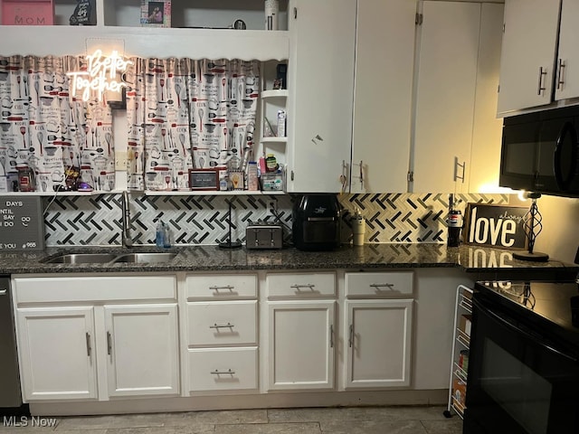 kitchen with black appliances, sink, dark stone countertops, and white cabinetry