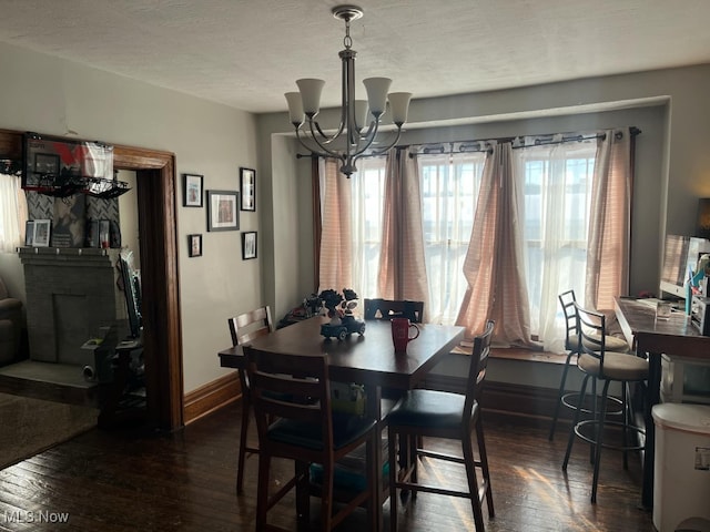 dining room featuring dark wood-type flooring and a notable chandelier