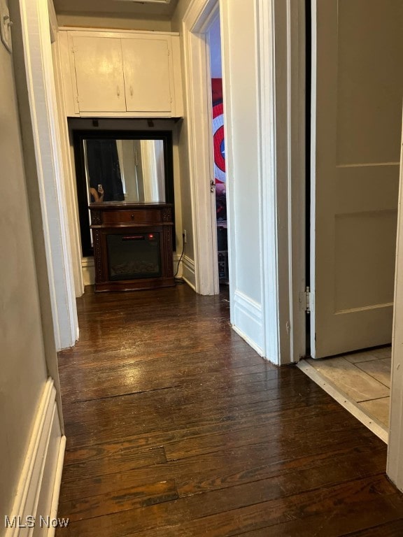 hallway with dark hardwood / wood-style flooring