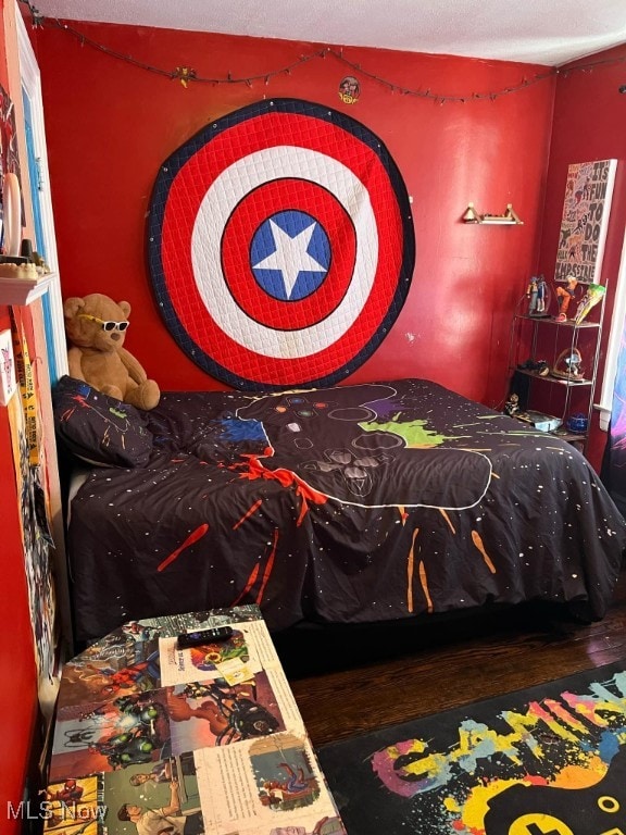 bedroom with hardwood / wood-style flooring