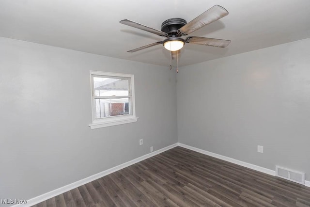 empty room with dark wood-type flooring and ceiling fan