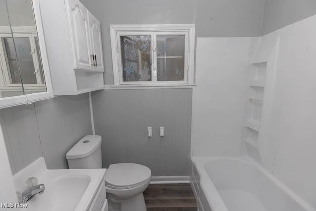 bathroom featuring vanity, hardwood / wood-style floors, and toilet