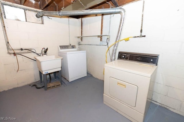 washroom with washing machine and clothes dryer and sink