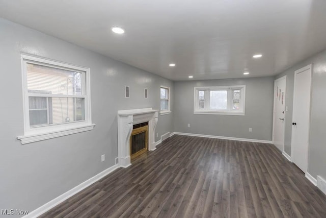 unfurnished living room with dark wood-type flooring