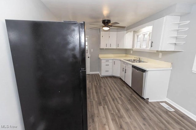 kitchen with black fridge, dishwasher, sink, and white cabinets