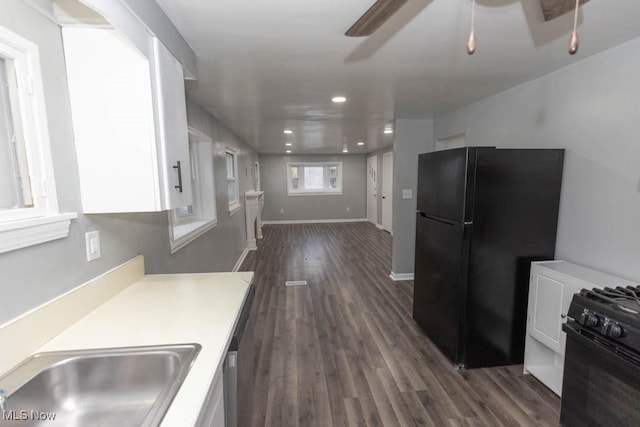 kitchen featuring dark hardwood / wood-style flooring, ceiling fan, black appliances, and white cabinets