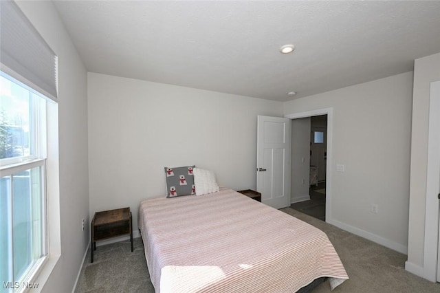 bedroom featuring dark colored carpet