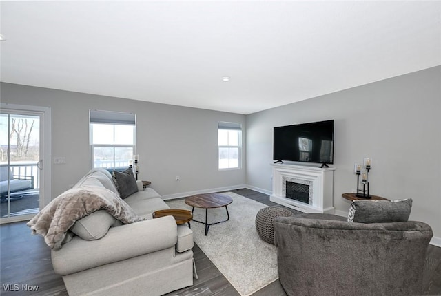 living room featuring a wealth of natural light and dark hardwood / wood-style flooring