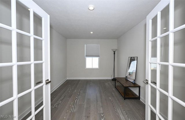 unfurnished room featuring dark wood-type flooring and french doors