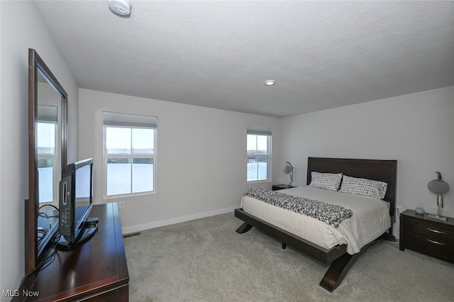 carpeted bedroom featuring a textured ceiling