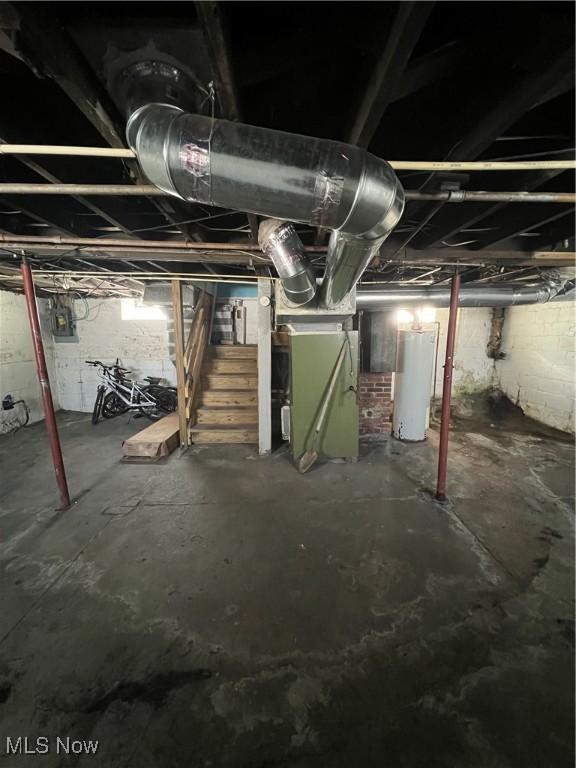 basement featuring heating unit and gas water heater