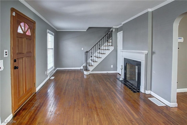 foyer featuring dark wood-type flooring and ornamental molding