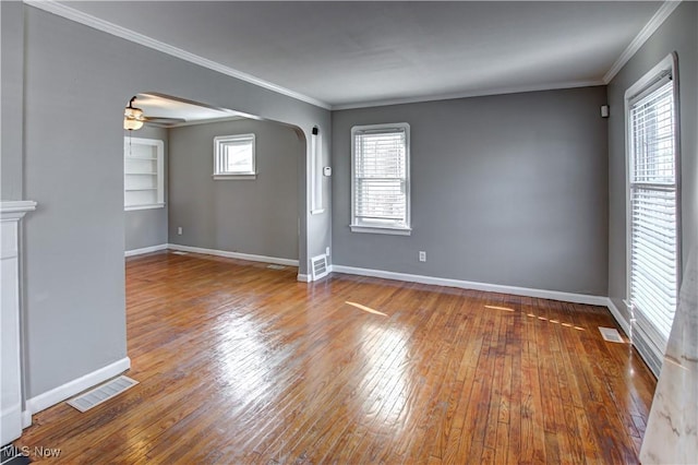 unfurnished living room featuring hardwood / wood-style floors, crown molding, and ceiling fan