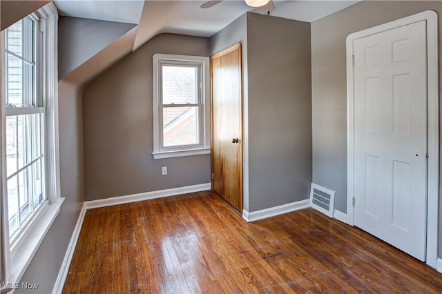 bonus room with dark wood-type flooring and ceiling fan