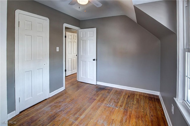 additional living space with lofted ceiling, hardwood / wood-style flooring, and ceiling fan