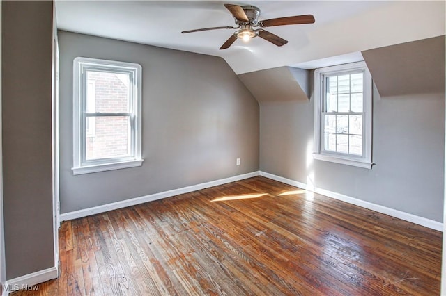 additional living space featuring vaulted ceiling, dark hardwood / wood-style floors, and ceiling fan