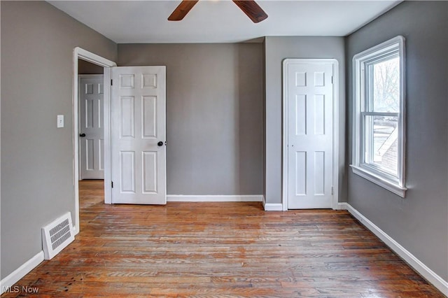 unfurnished bedroom with ceiling fan and light wood-type flooring