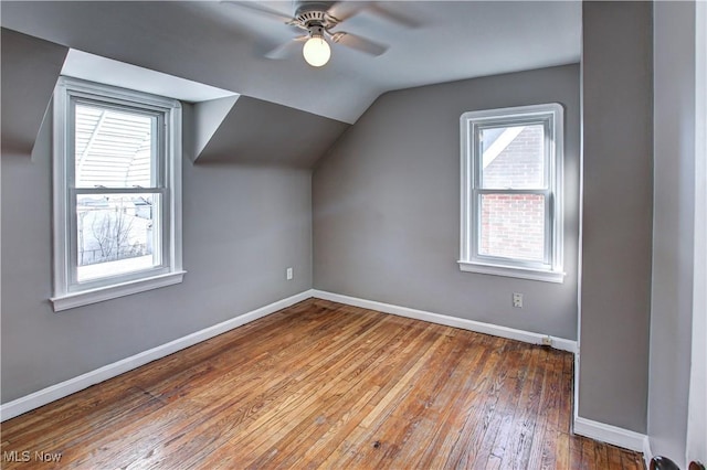 bonus room featuring lofted ceiling, hardwood / wood-style floors, a wealth of natural light, and ceiling fan